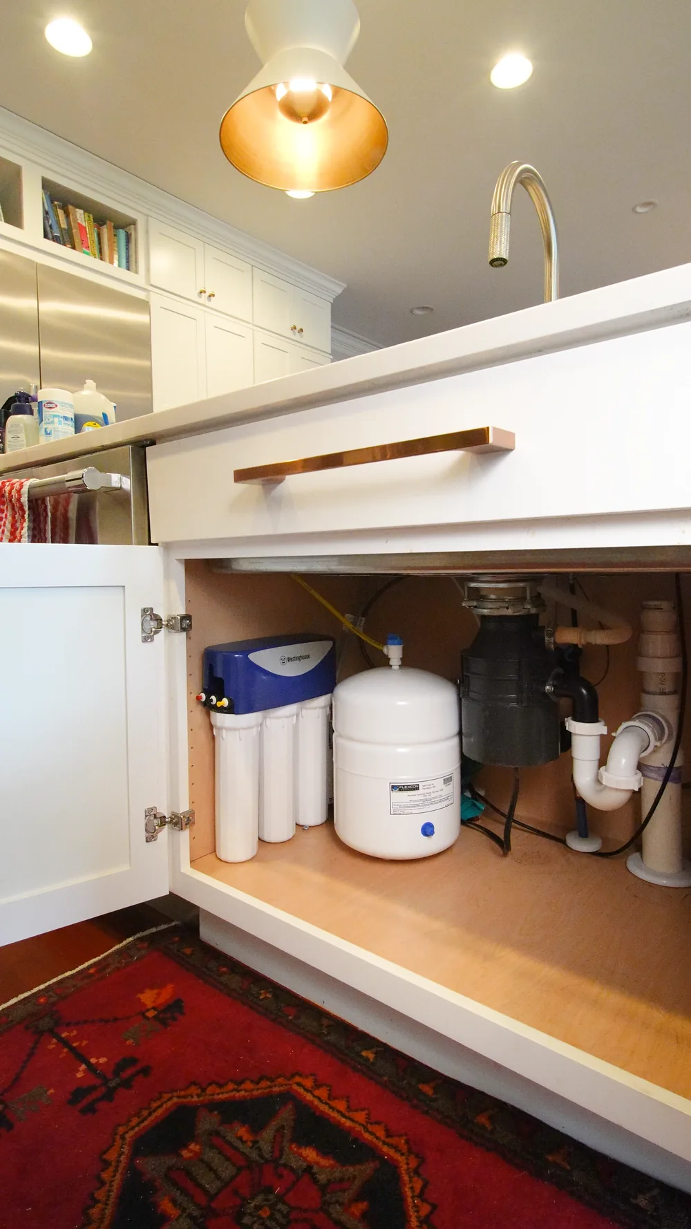 Reverse osmosis system installed under a kitchen sink by Genius Water Co.