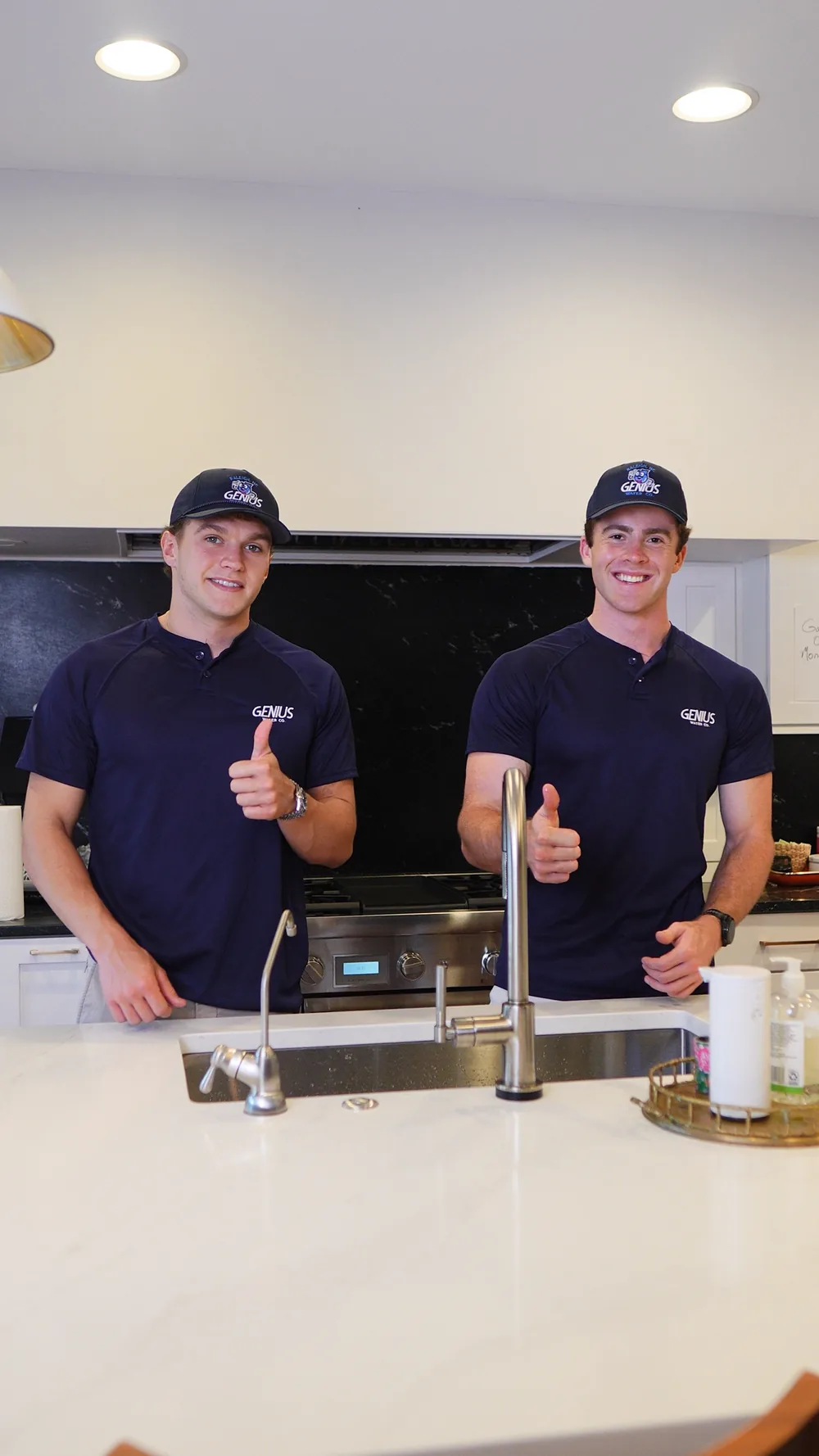 Genius Water Co. technicians demonstrating water quality at a kitchen sink