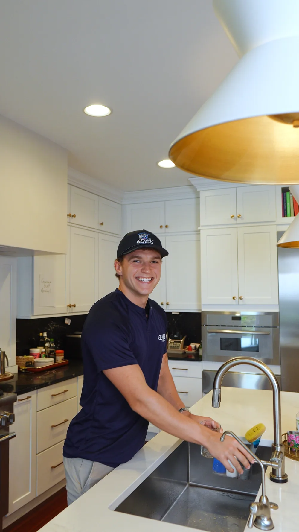 Genius Water Co. technician testing water at a kitchen sink